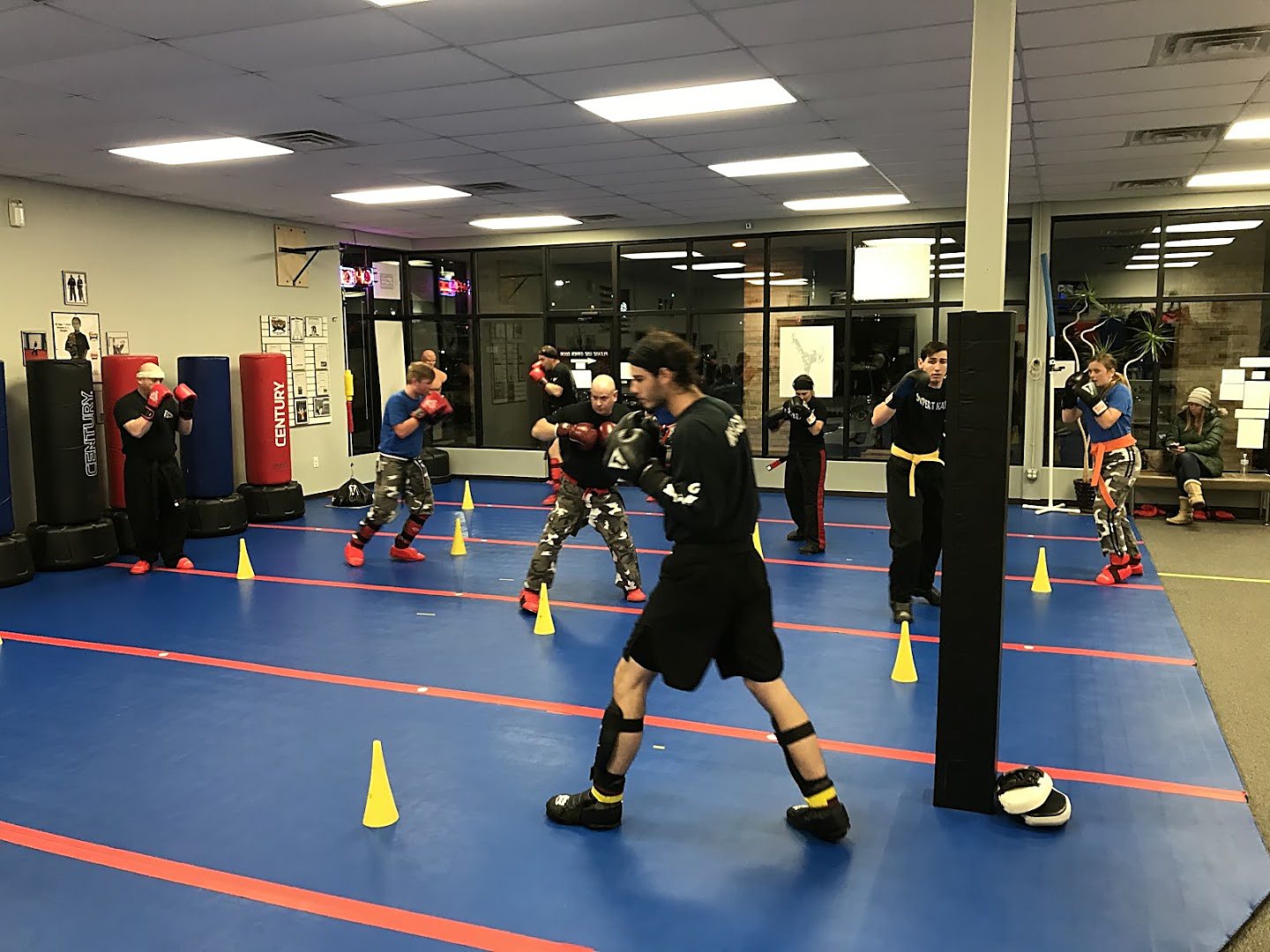 An instructor supervising Get Strong. students closely during class at Super T Karate in Grand Rapids