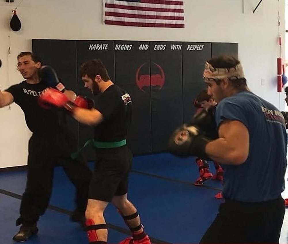 Adults training kickboxing on pads at Super T Karate in Grand Rapids