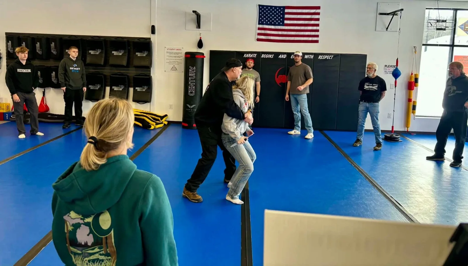 Adults practicing defensive drills on the mats during an EDC Tactics class at Super T Karate in Grand Rapids