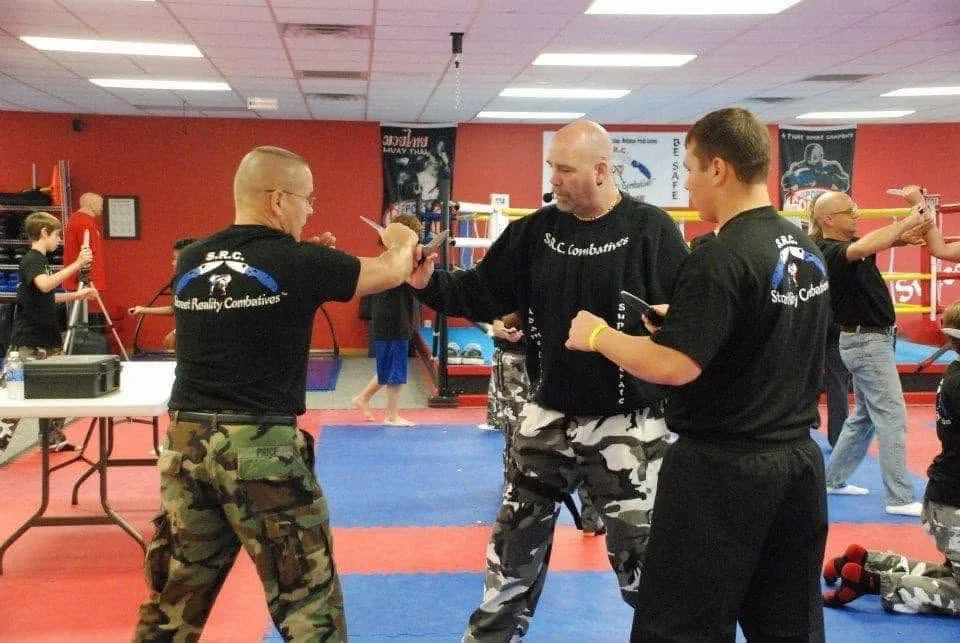 An adult practicing self-defense with an instructor at Super T Karate