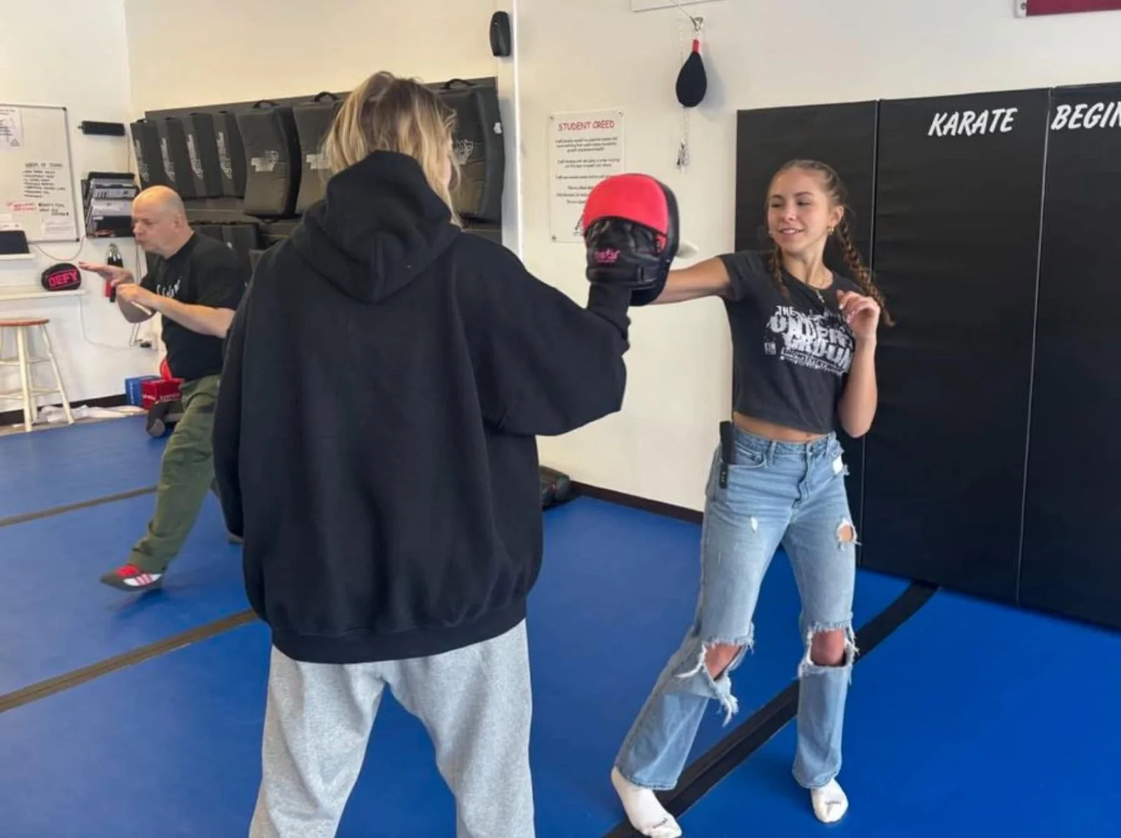 A student throwing a palm strike into a focus mitt during EDC Tactics training at Super T Karate in Grand Rapids