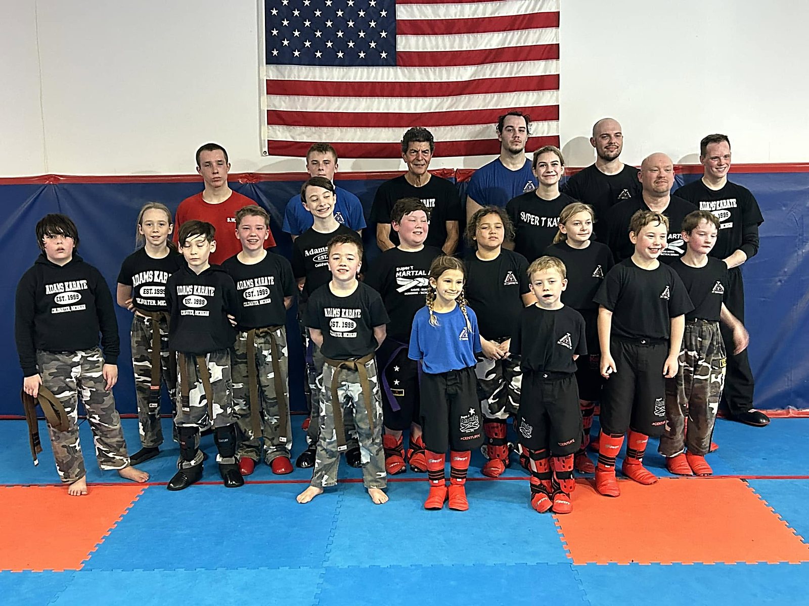 Students and instructors in front of the American flag at Super T Karate in Grand Rapids