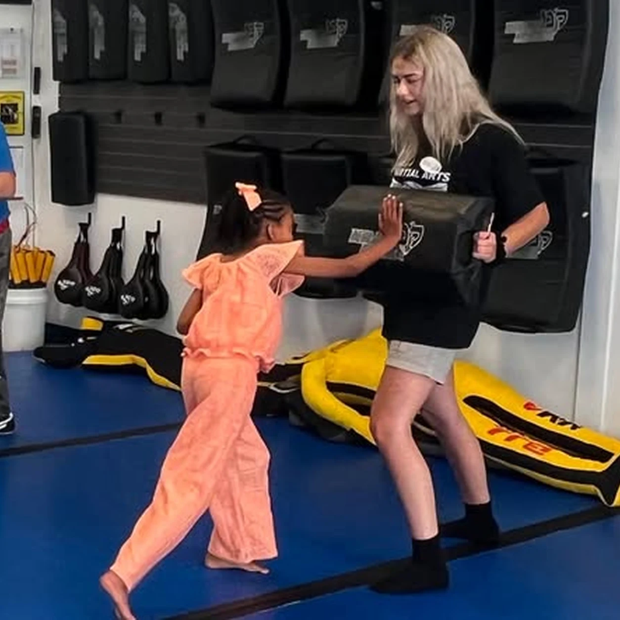 An instructor supervising Is Your Preschooler students closely during class at Super T Karate in Grand Rapids