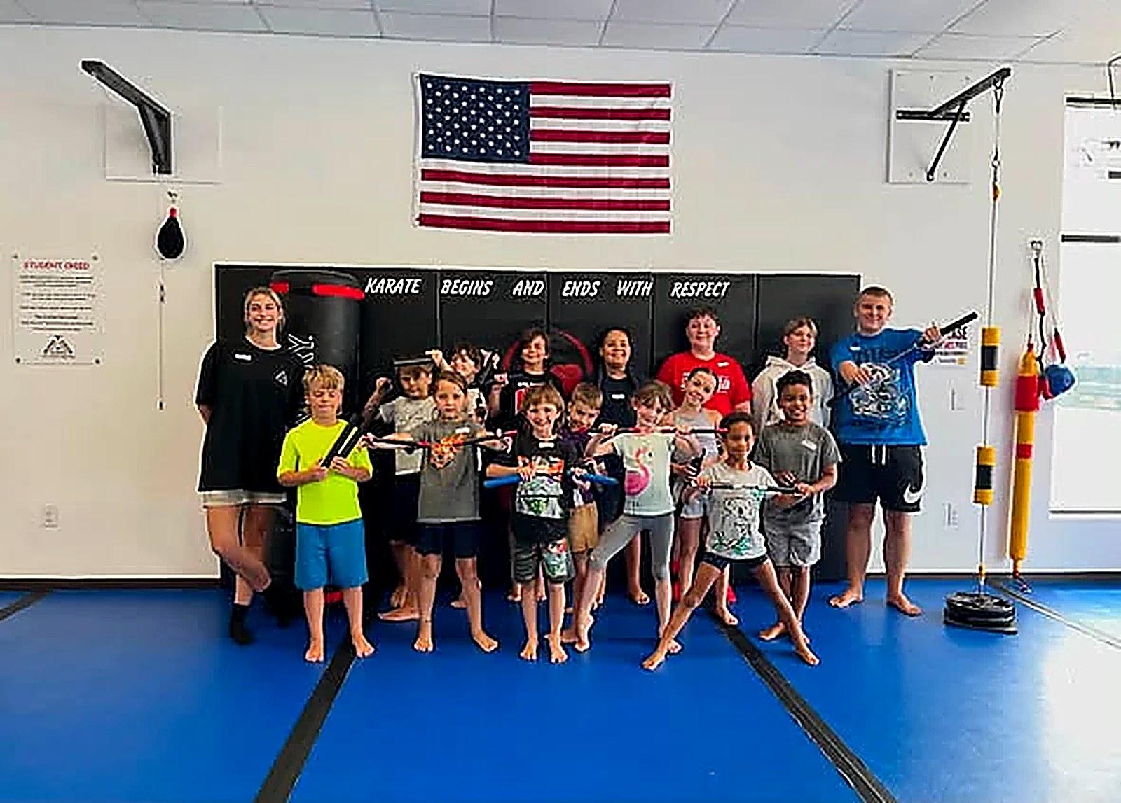 A group of smiling kids celebrating together at the end of class at Super T Karate in Grand Rapids